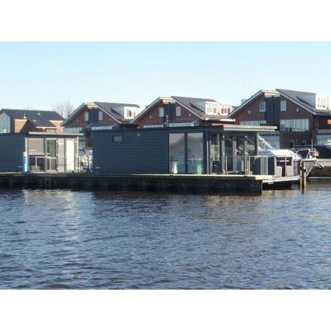 Modern houseboat with air conditioning located in marina