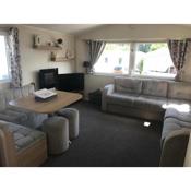 Stunning deluxe 3 bedroomed caravan with CH, DG and decking.
