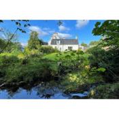 Traditional farm cottage with woodburner by stream