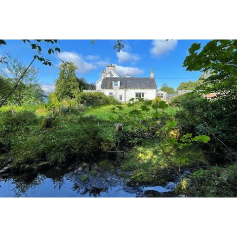 Traditional farm cottage with woodburner by stream