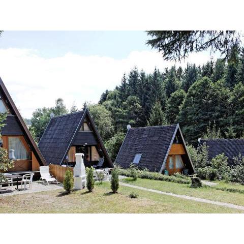 Wooden chalet with terrace near a swimming lake